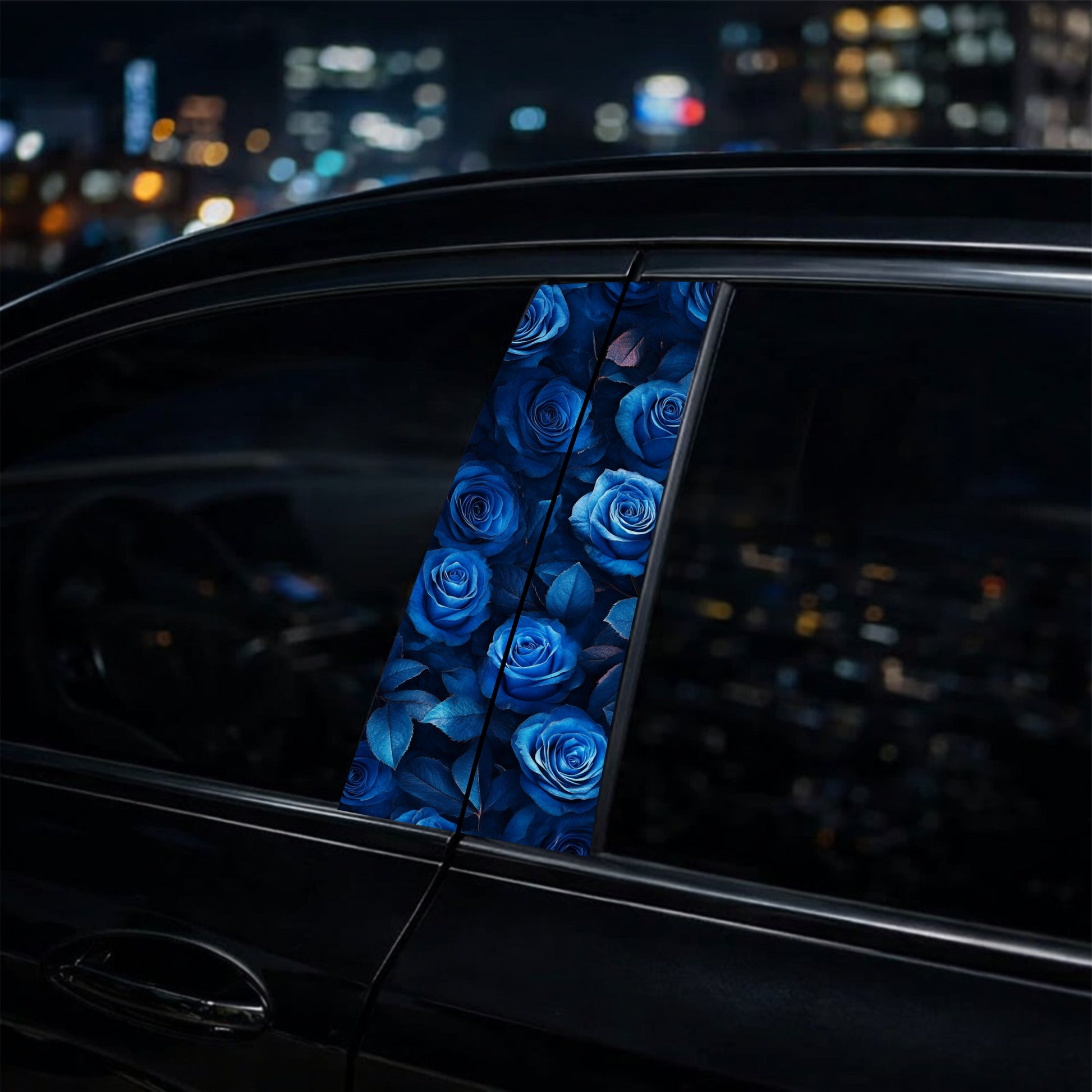 Car window with blue rose pattern against a cityscape at night